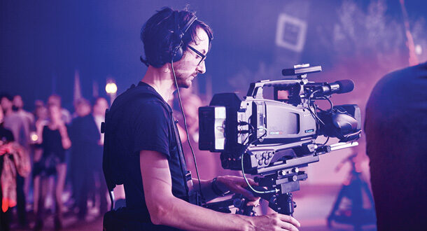 Cameraman filming at event.