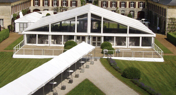 White event tent in front of castle