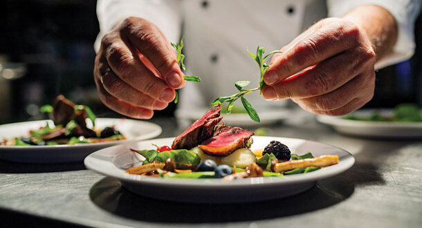 Chef preparing a plate for a wedding menu.