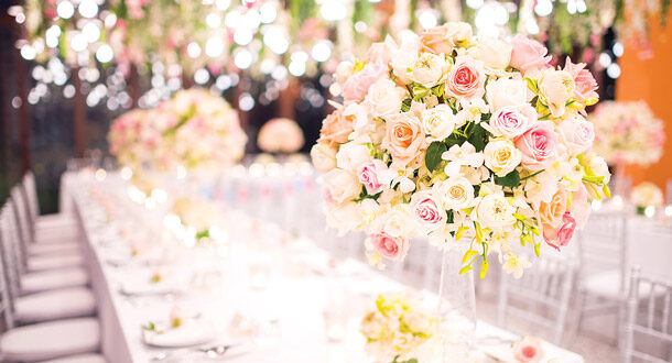 Flower arrangements on decorated wedding table.