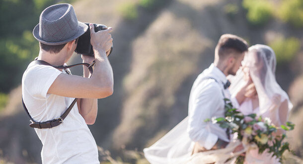 Photographer taking a picture of wedding couple.